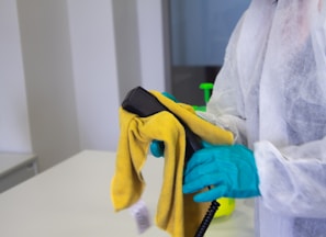 person in white robe holding black and yellow umbrella