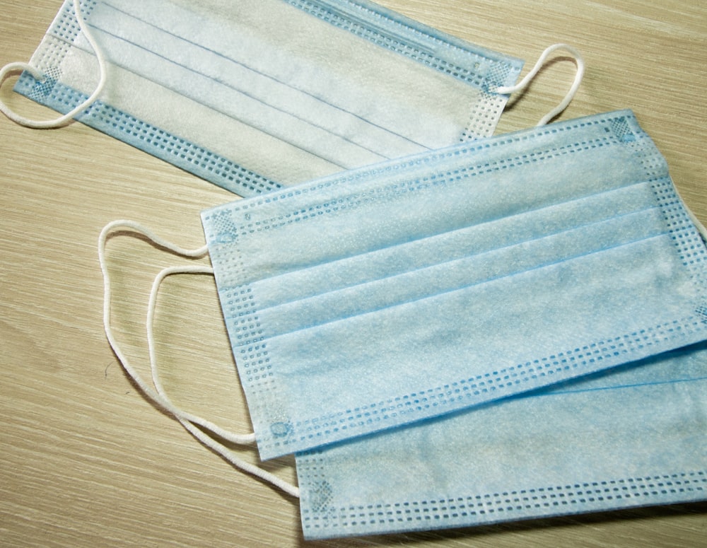 blue leather pouch on brown wooden table