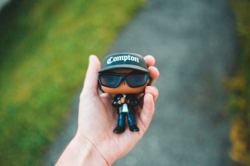 Close-up of hands holding a limited-edition gaming figure from byxxe shop.