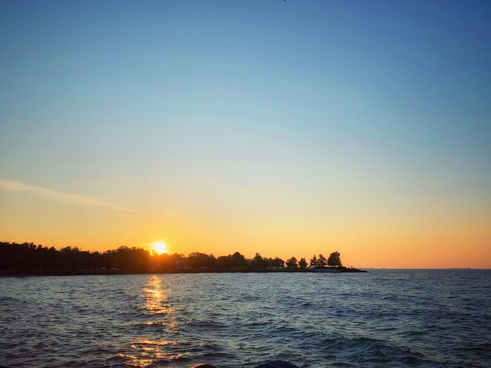 silhouette of island during sunset