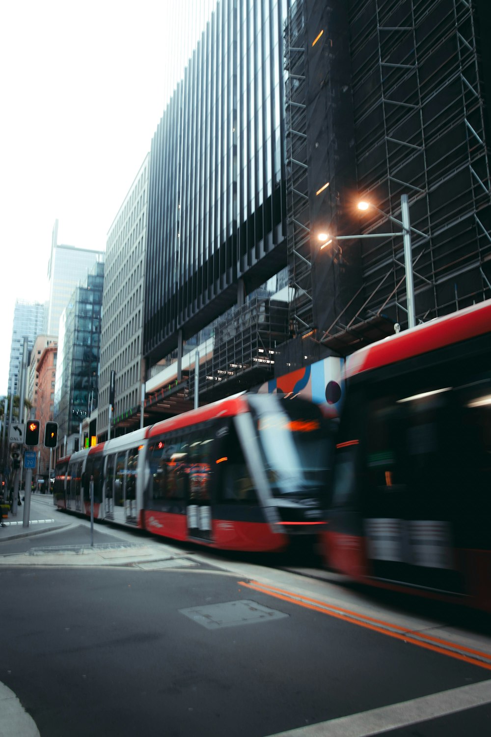 red and white train on the city during daytime