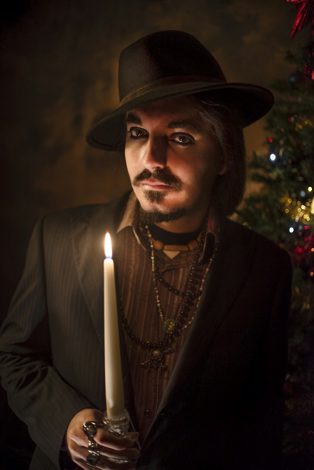 man in black suit jacket wearing brown hat