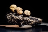 Close-up of handcrafted Amazonian truffles with exotic fruit fillings on a rustic wooden table.