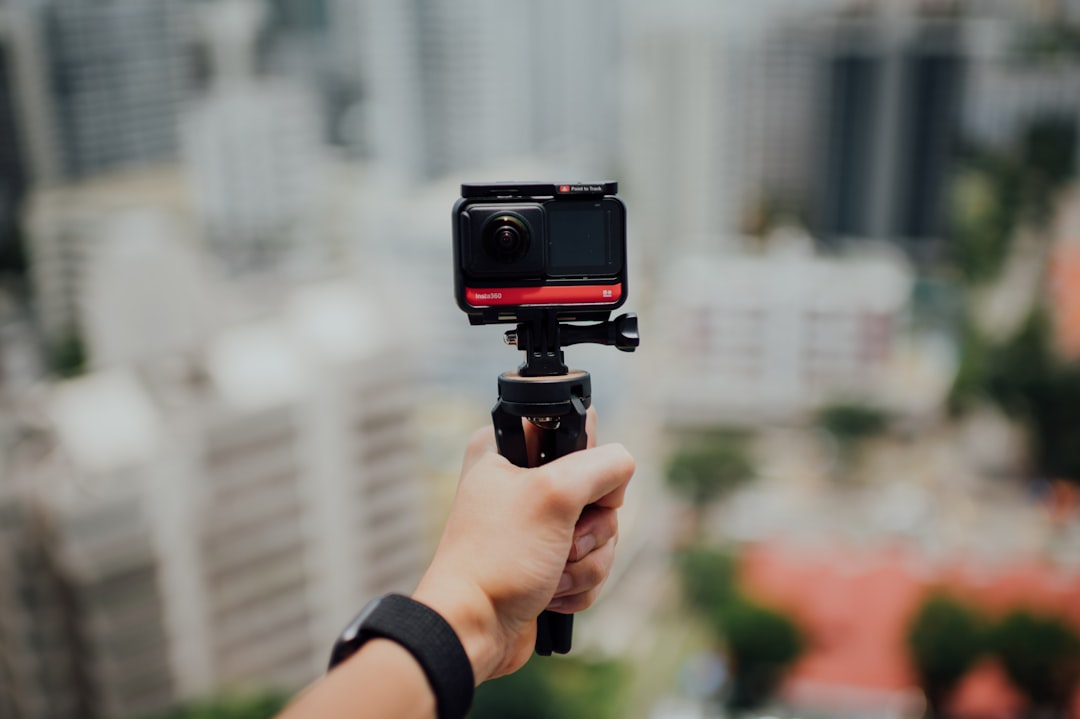 person holding black dslr camera