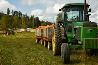 green tractor on green grass field during daytime