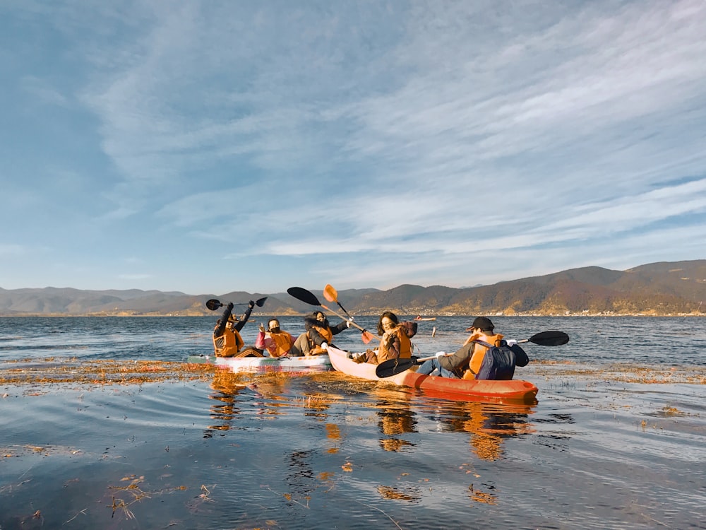 people riding on kayak on sea during daytime