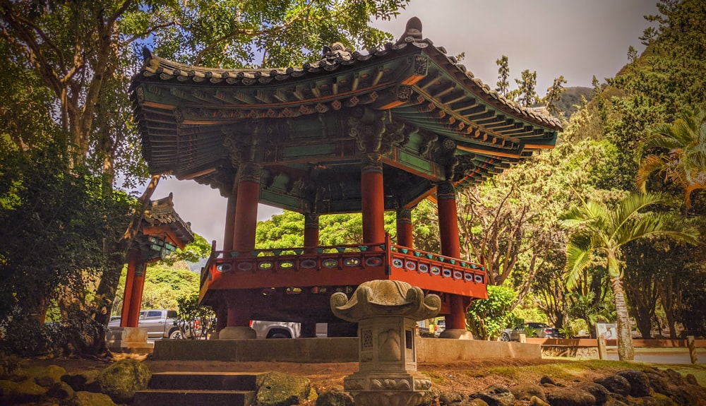 brown wooden gazebo near green trees during daytime