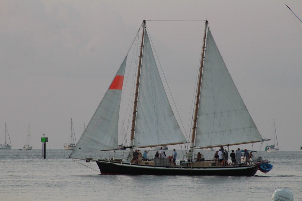 white sail boat on sea during daytime