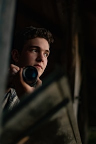 A dynamic portrait of the director deep in thought with a camera in hand.