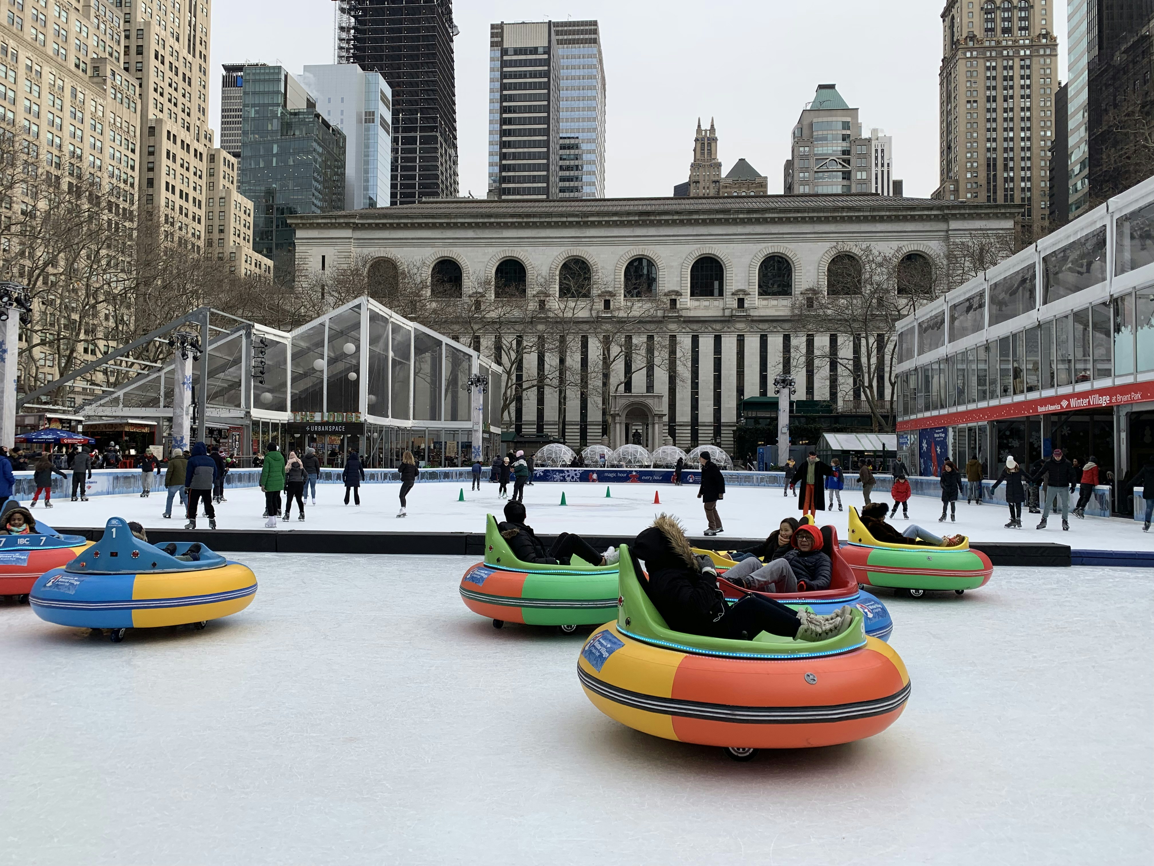 A group of people riding in bumper boats on an ice rink photo – Free ...