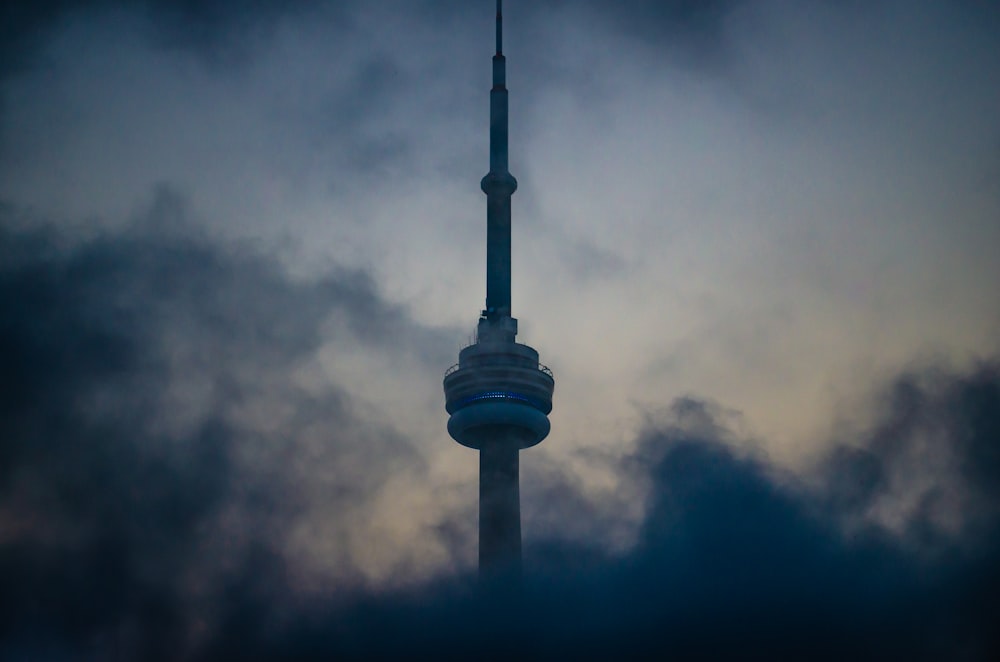 white and black tower under cloudy sky