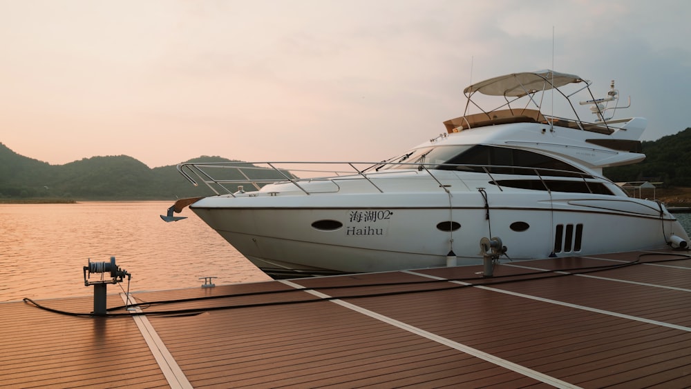 white and black motor boat on dock during daytime