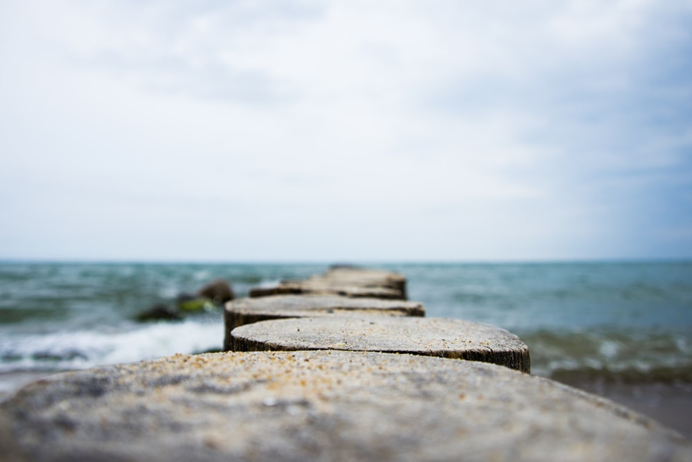 gray concrete dock near body of water during daytime