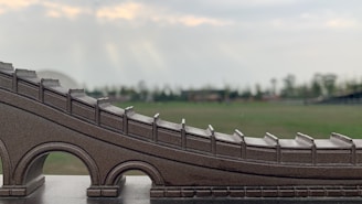 Close-up of a bridge model being assembled by attentive course participants