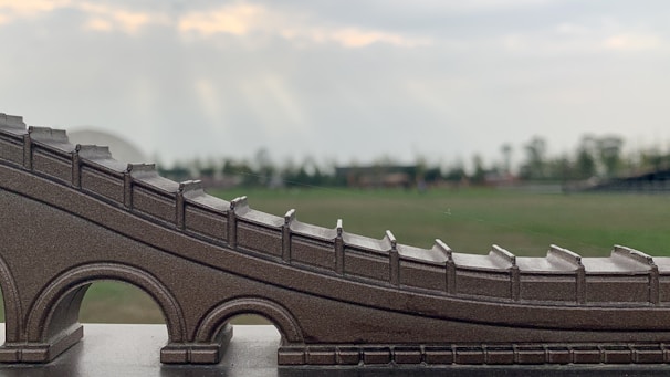 Close-up of a bridge model being assembled by attentive course participants
