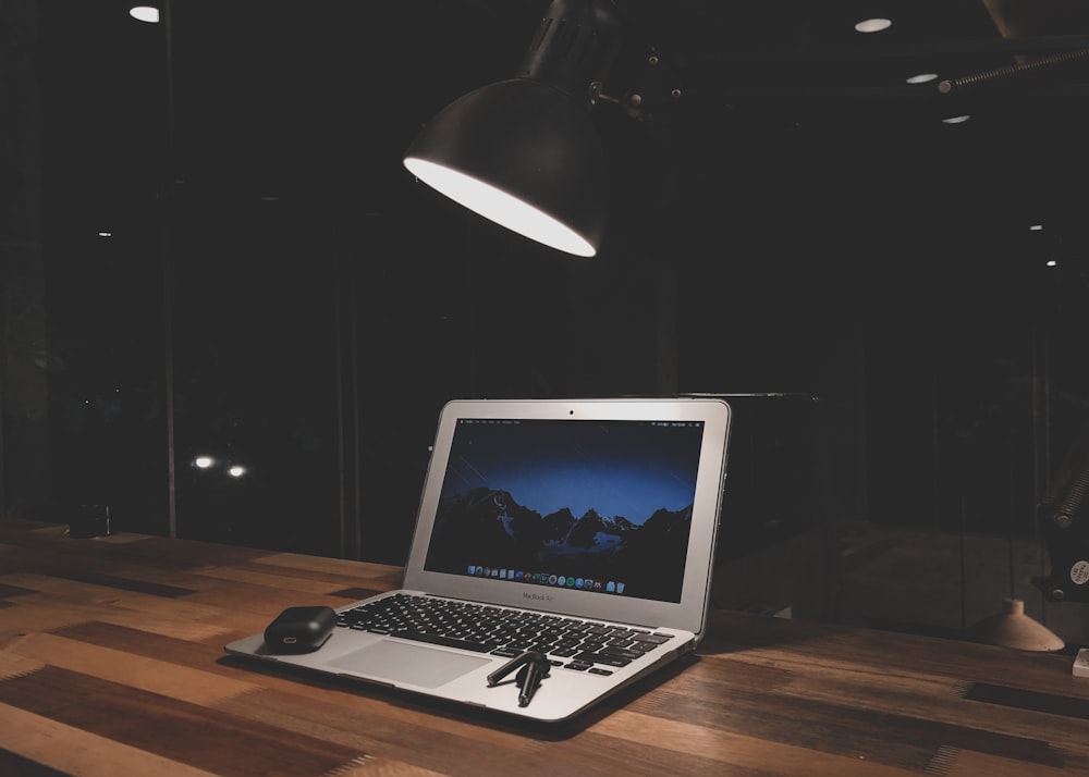 macbook pro on brown wooden table