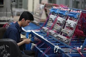 man in blue polo shirt standing in front of shopping cart