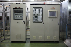 Engineers inspecting a high-tech railway control panel in a clean, well-lit facility