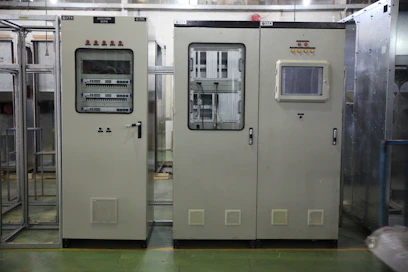 Technician setting up a fire alarm panel inside a modern office building