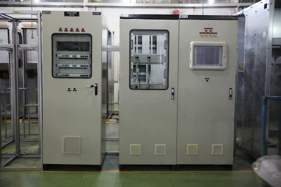 Industrial control panel installed in a factory setting with heavy machinery