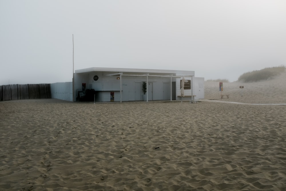 white concrete building on brown sand during daytime