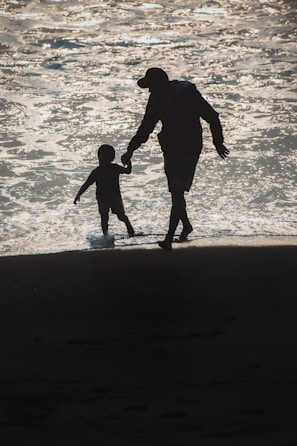 A father and daughter praying hand in hand on a sunny morning walk.