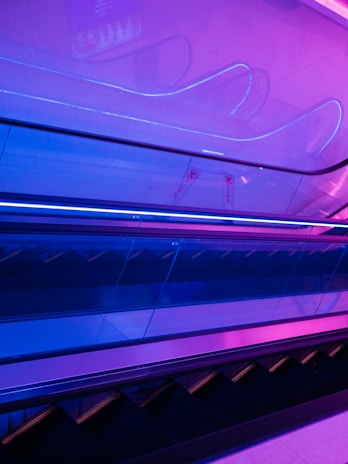 A vibrant elevator interior featuring a digital screen displaying a colorful advertisement.