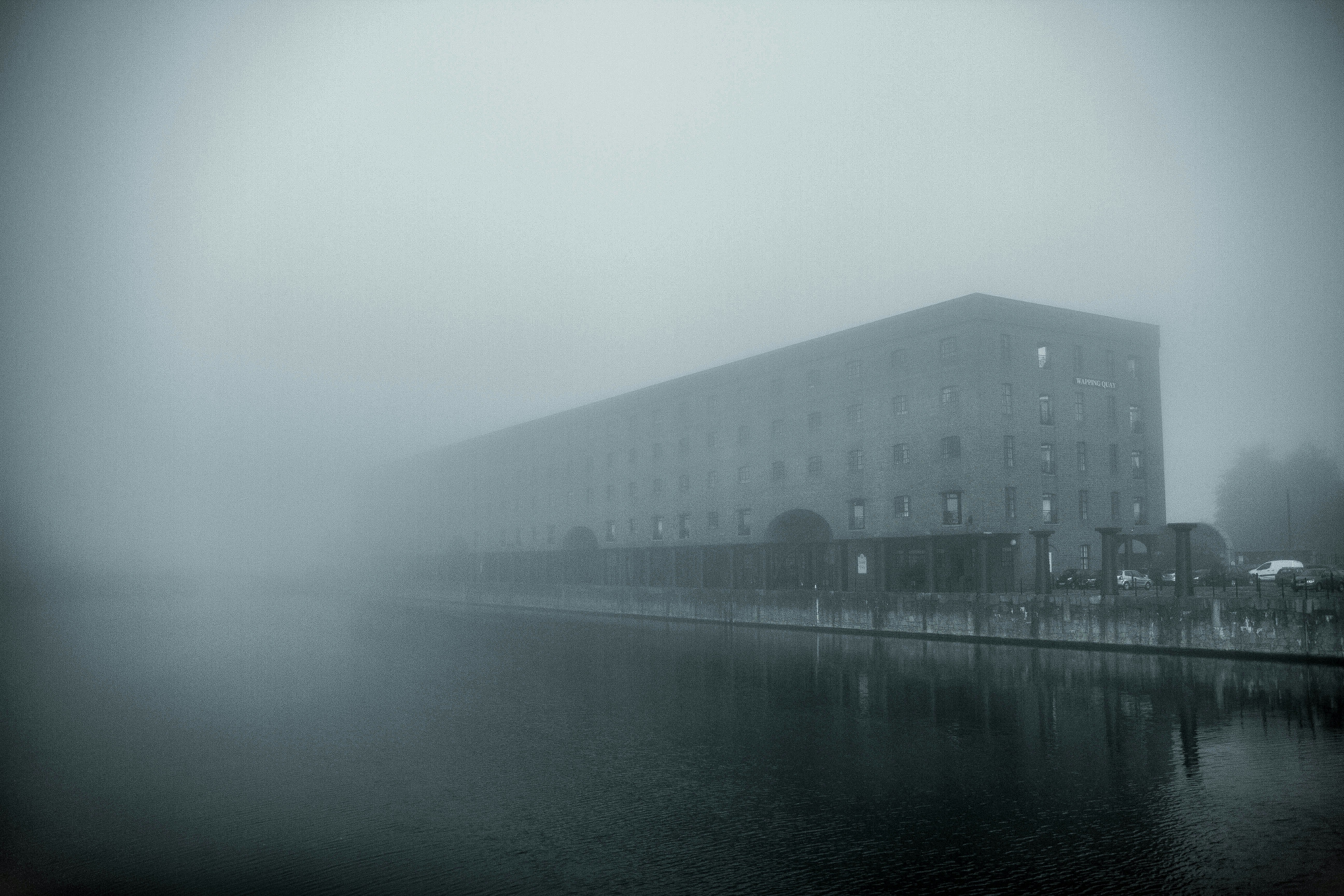 white concrete building near body of water during daytime