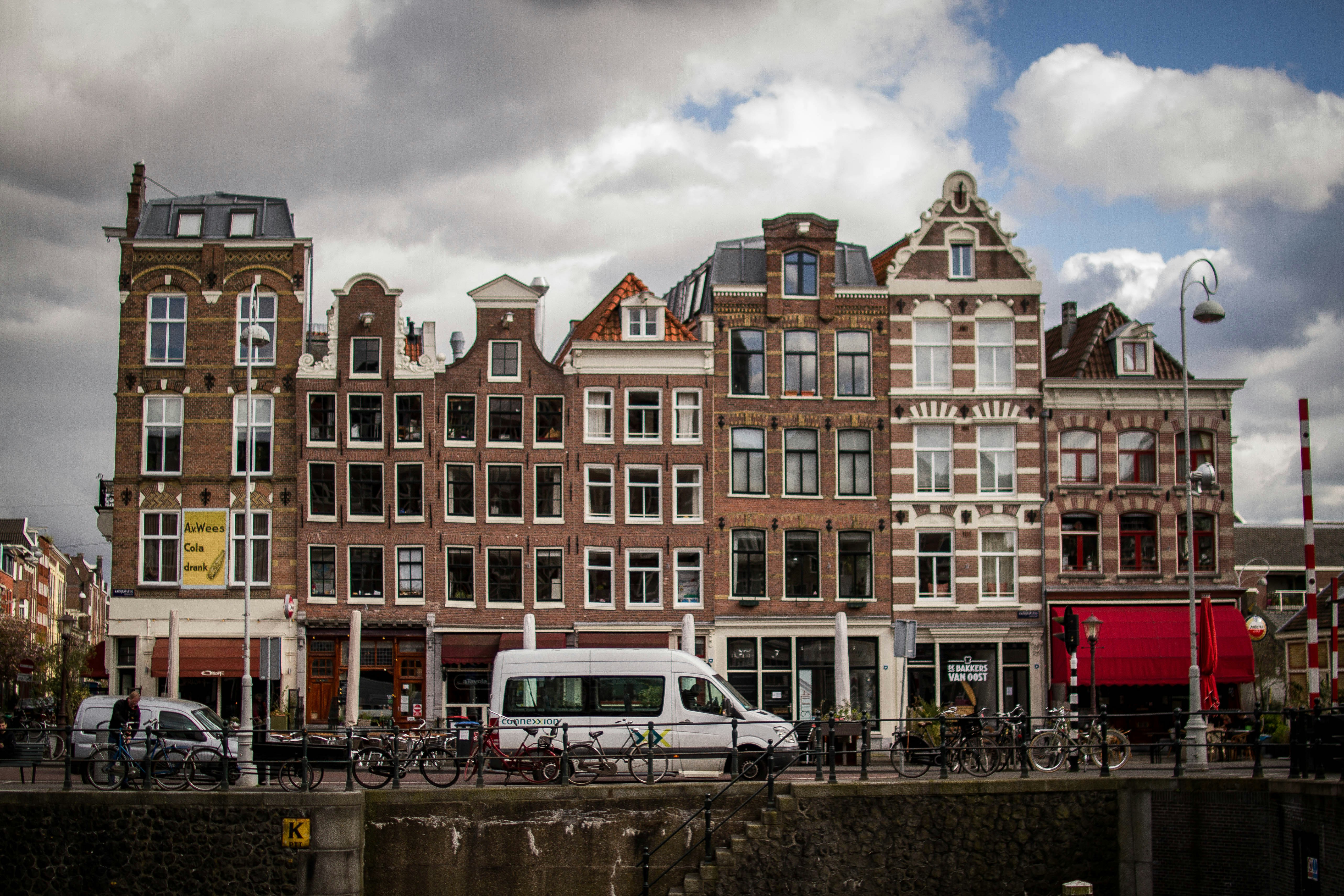 white and brown concrete building near body of water during daytime