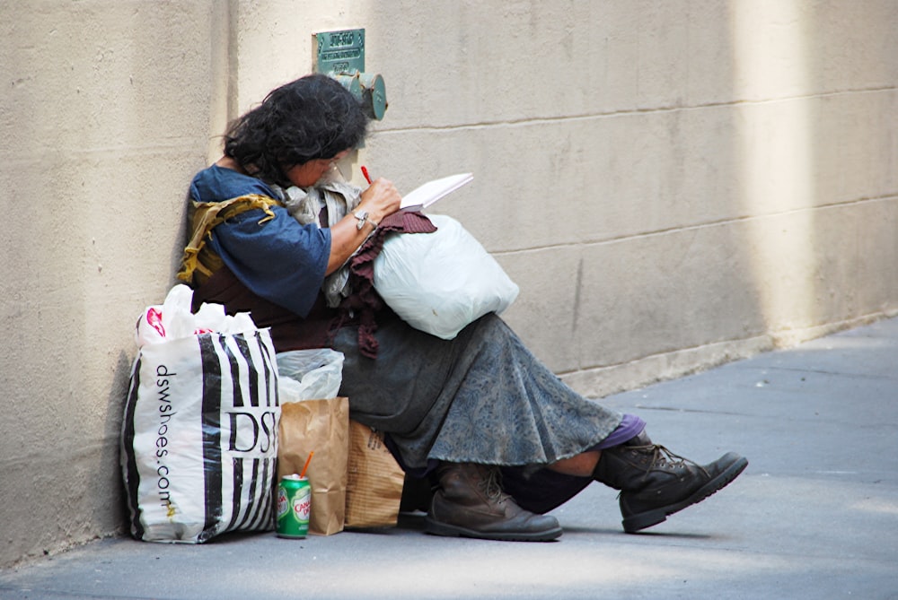 woman in black leather jacket sitting on concrete bench