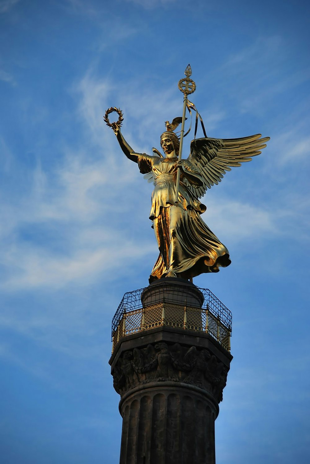 gold angel statue under blue sky during daytime