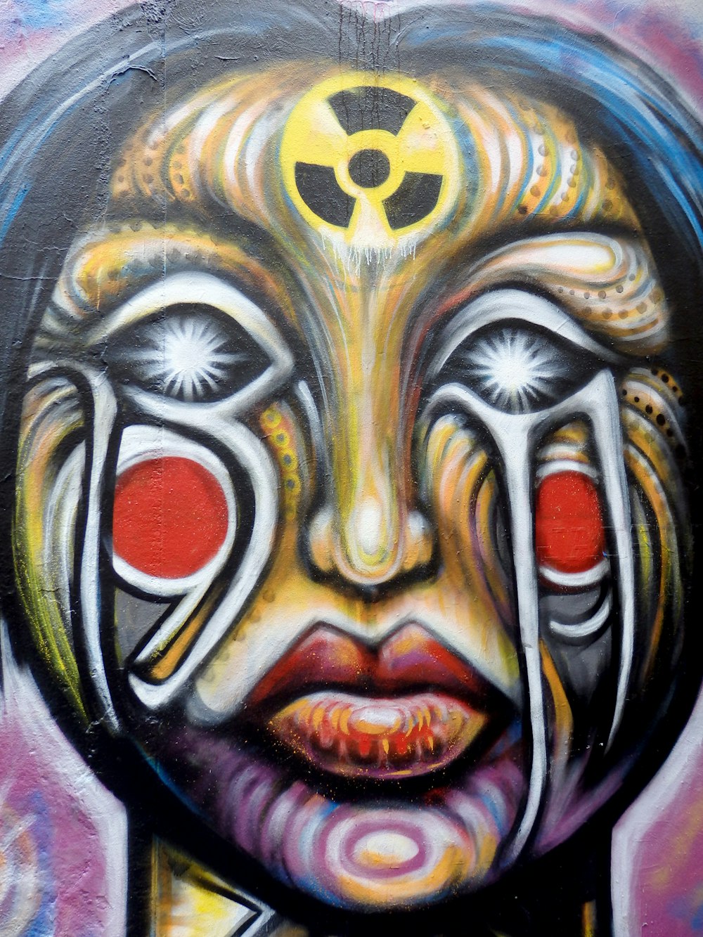 a painting of a woman's face painted on a wall