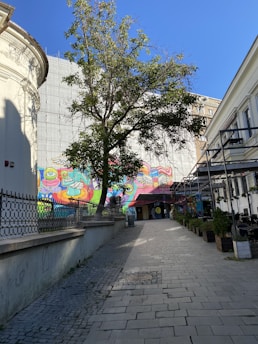 A vibrant street scene in Atlanta with colorful murals and people enjoying a sunny day.