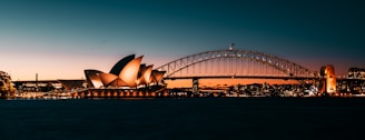 the sydney opera house is lit up at night