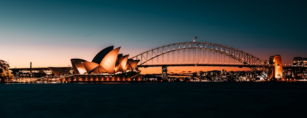 the sydney opera house is lit up at night