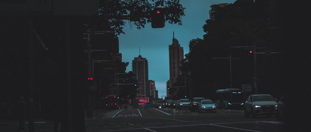 city buildings and cars on road during night time