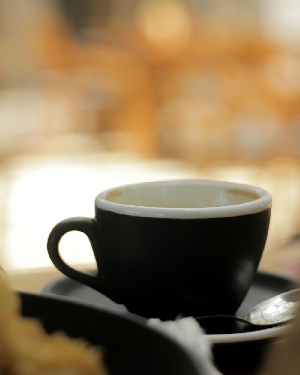 black ceramic mug on saucer