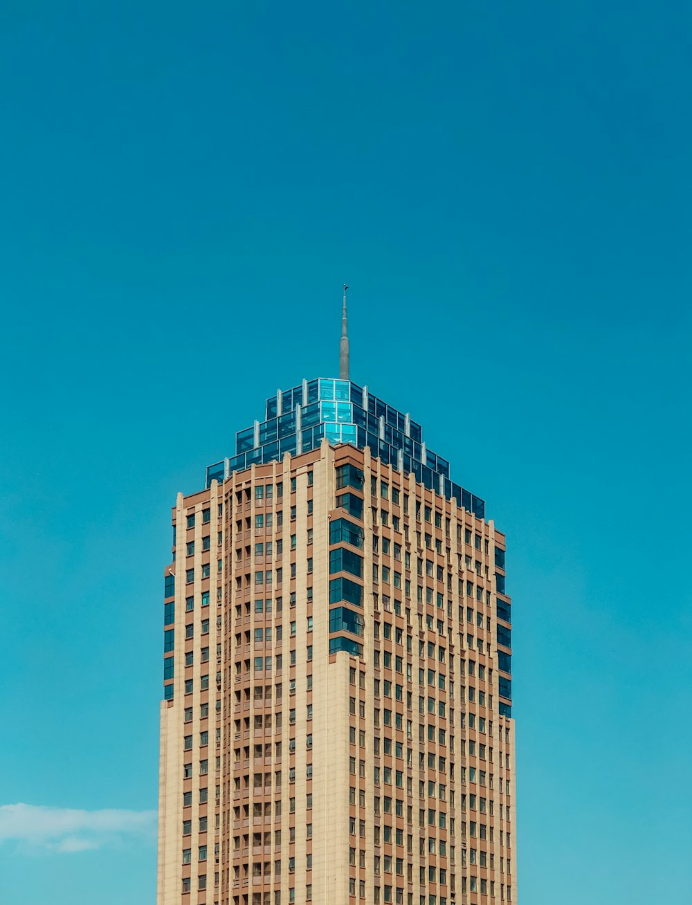 brown and white concrete building under blue sky during daytime