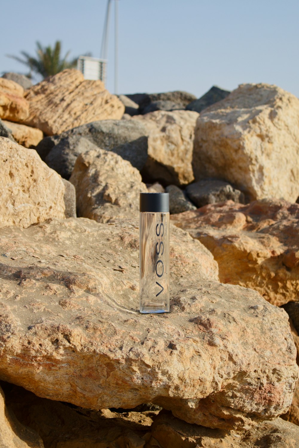 clear glass bottle on brown rock