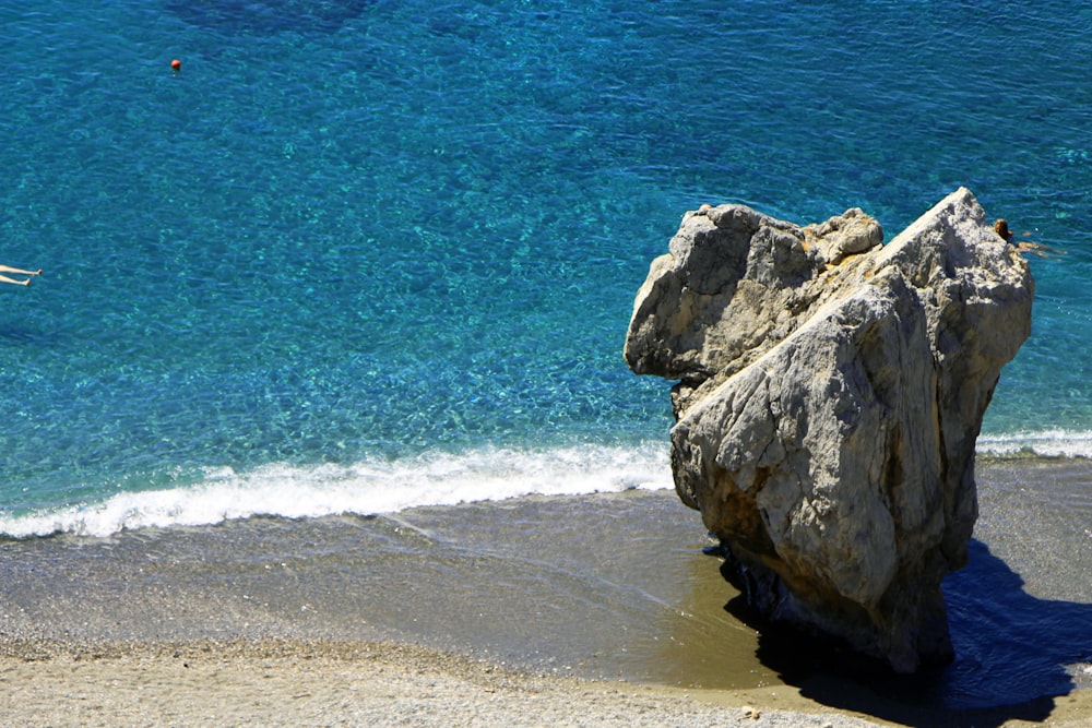 gray rock formation on sea shore during daytime