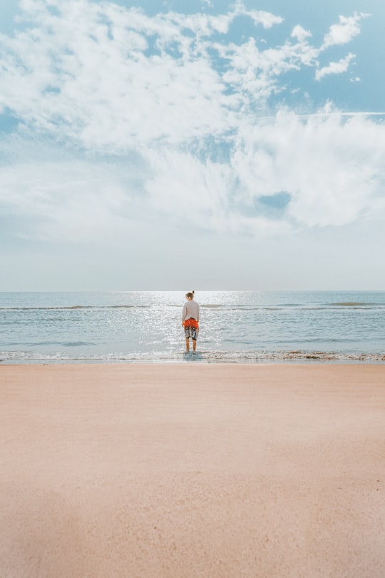 woman in red shorts walking on beach during daytime in Bushehr Iran