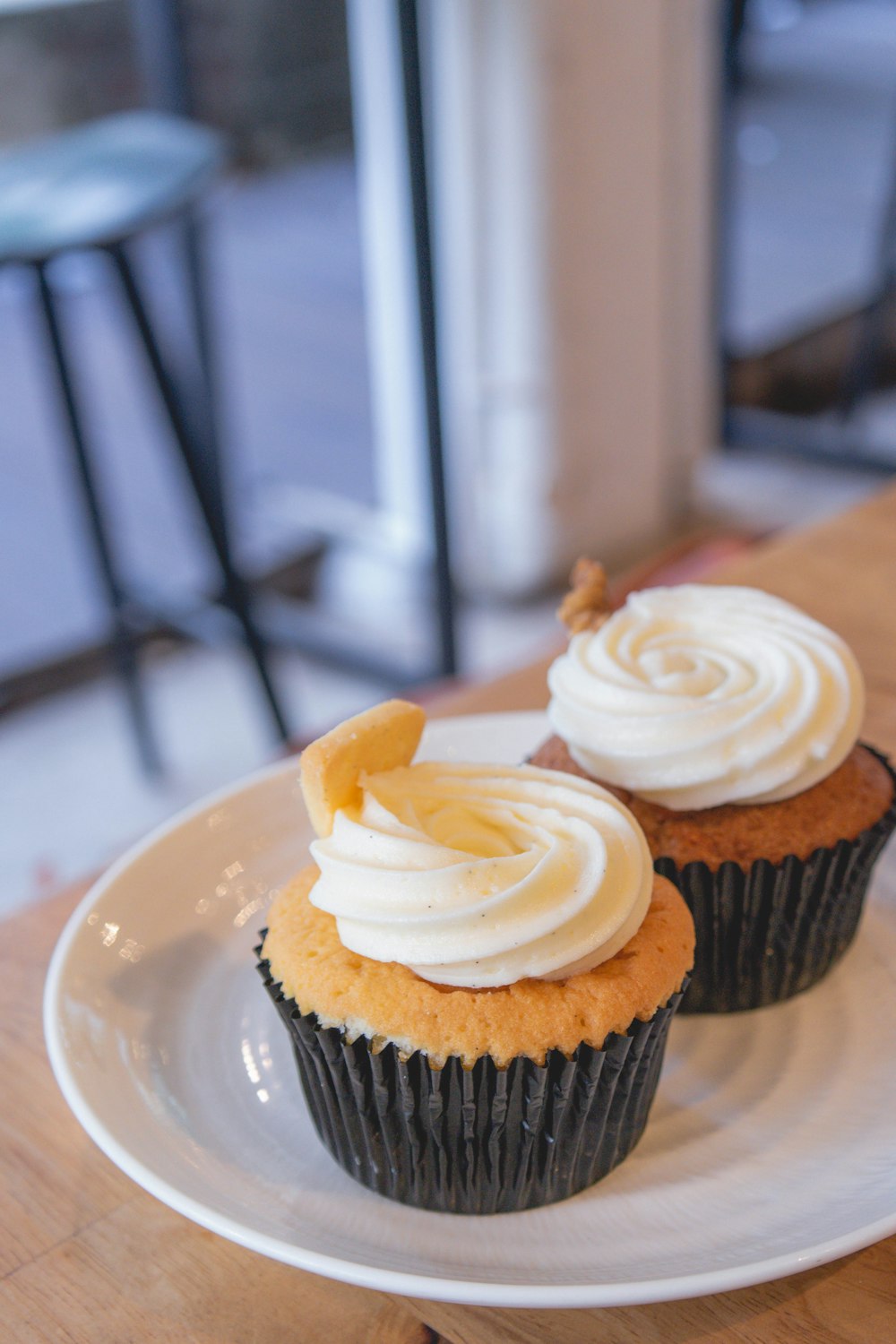 cupcake with white icing on white ceramic plate