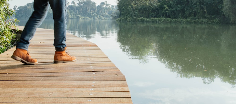 brown wooden dock on lake during daytime