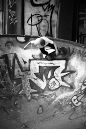 man in black and white shirt and black pants standing on basketball court