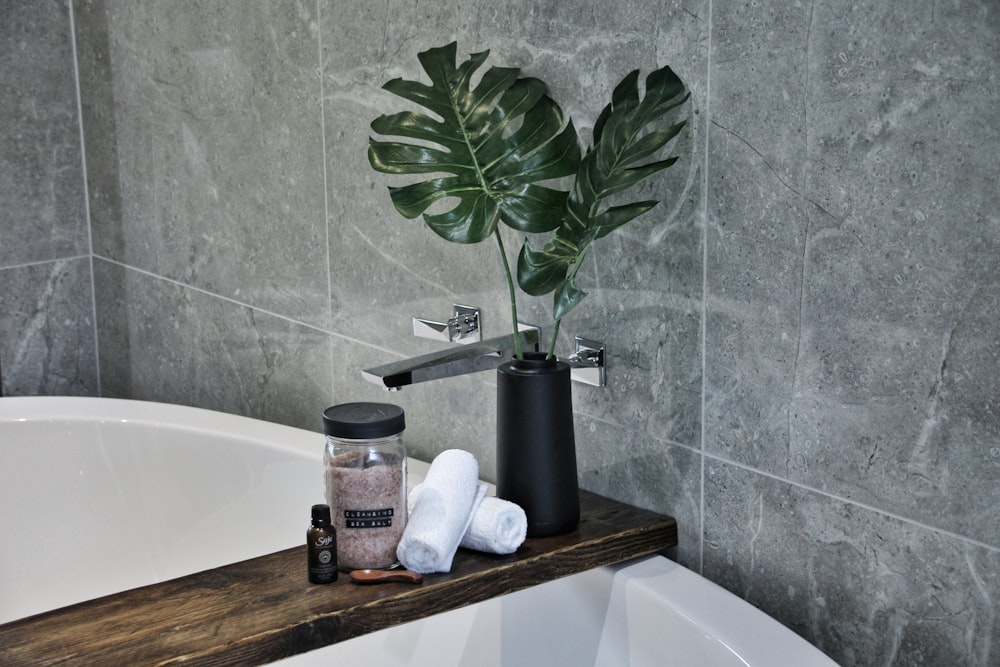 white ceramic bathtub with soap bottles