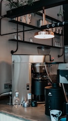 A cozy coffee shop setting with Qubicup coffee products displayed.