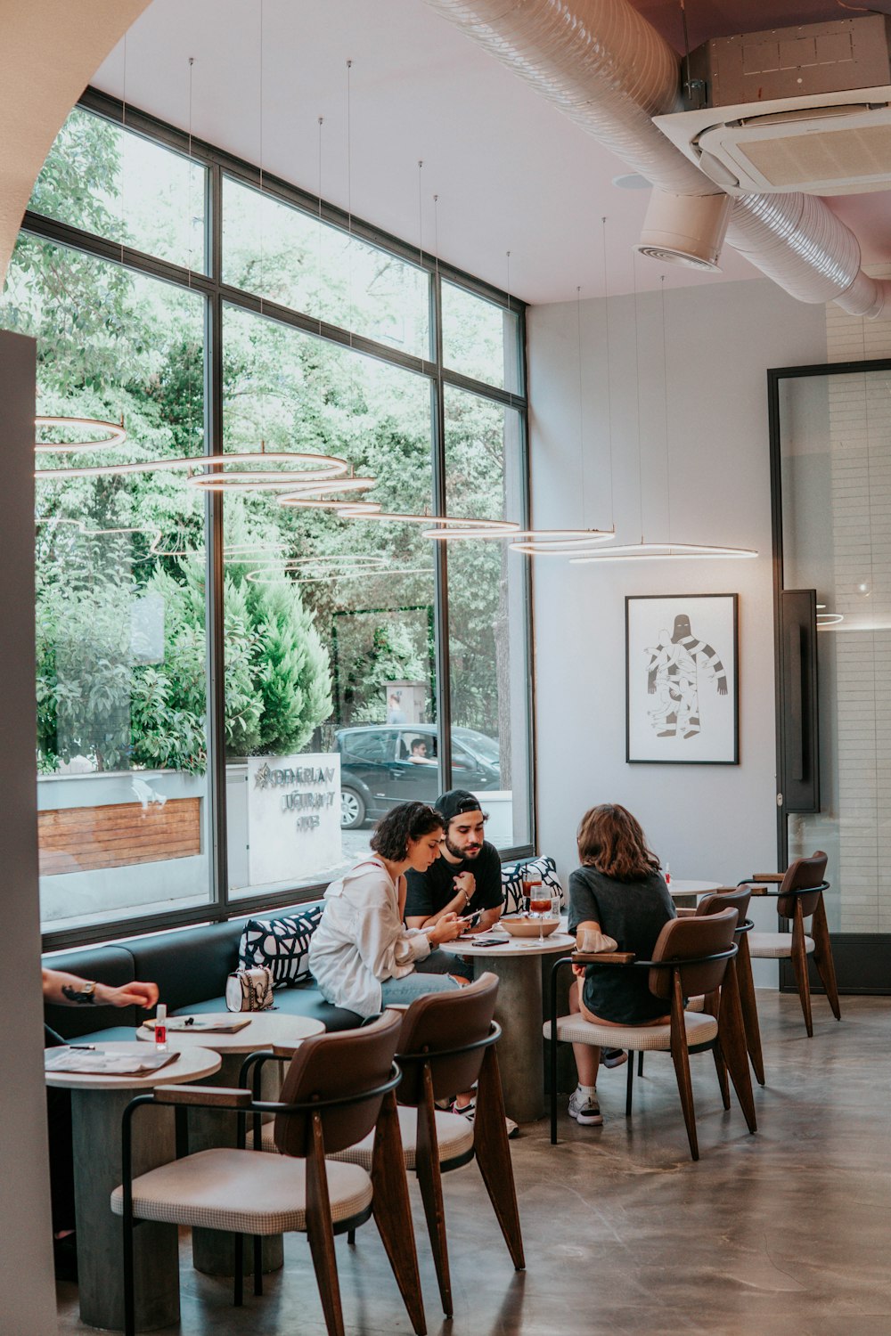 people sitting on brown wooden chairs