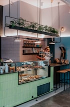 man in black t-shirt standing in front of counter