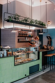 man in black t-shirt standing in front of counter