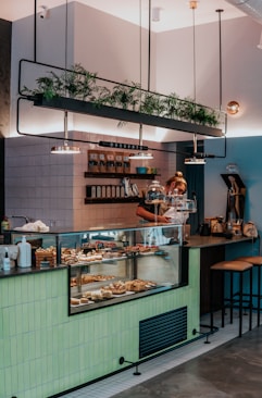 man in black t-shirt standing in front of counter
